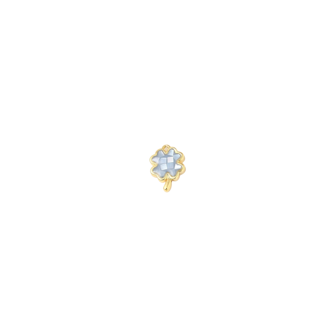 Gold earring with a central gemstone on a white background