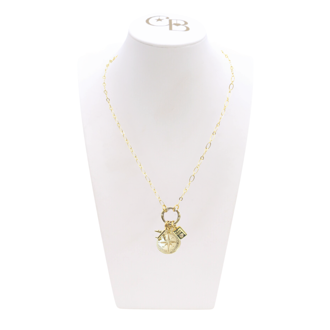 Gold necklace with a pendant on a white mannequin bust