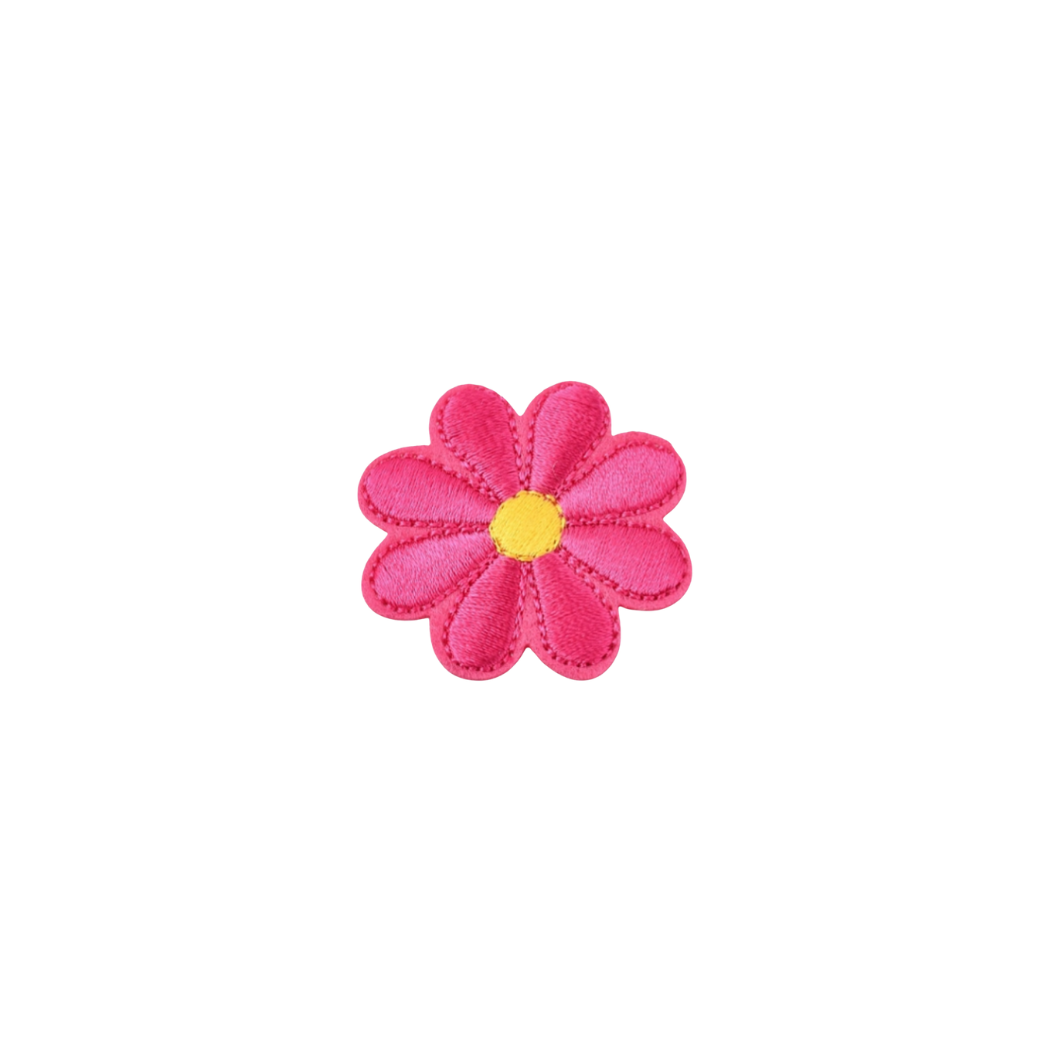 Pink flower-shaped object with a yellow center on a white background