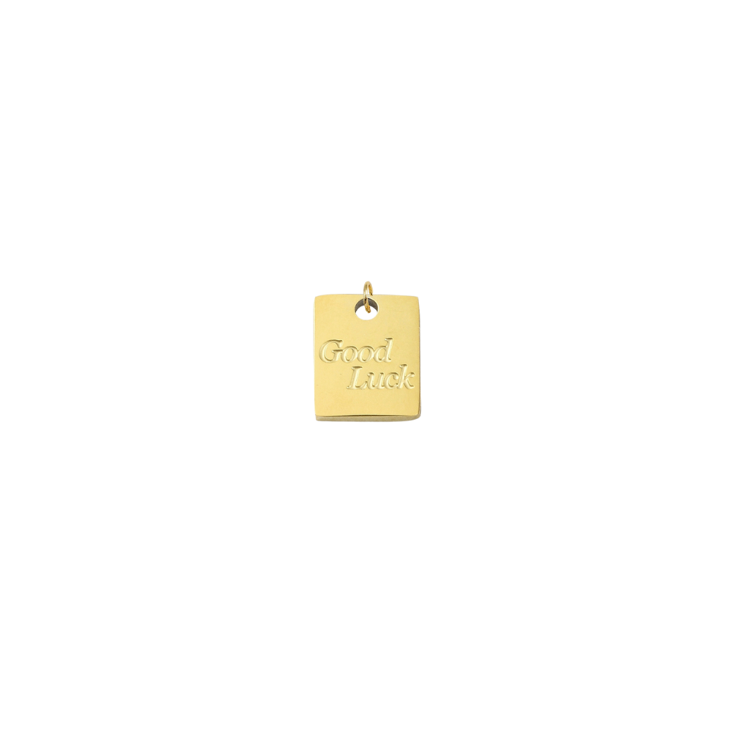 Gold pendant with 'Good Luck' engraving on a white background