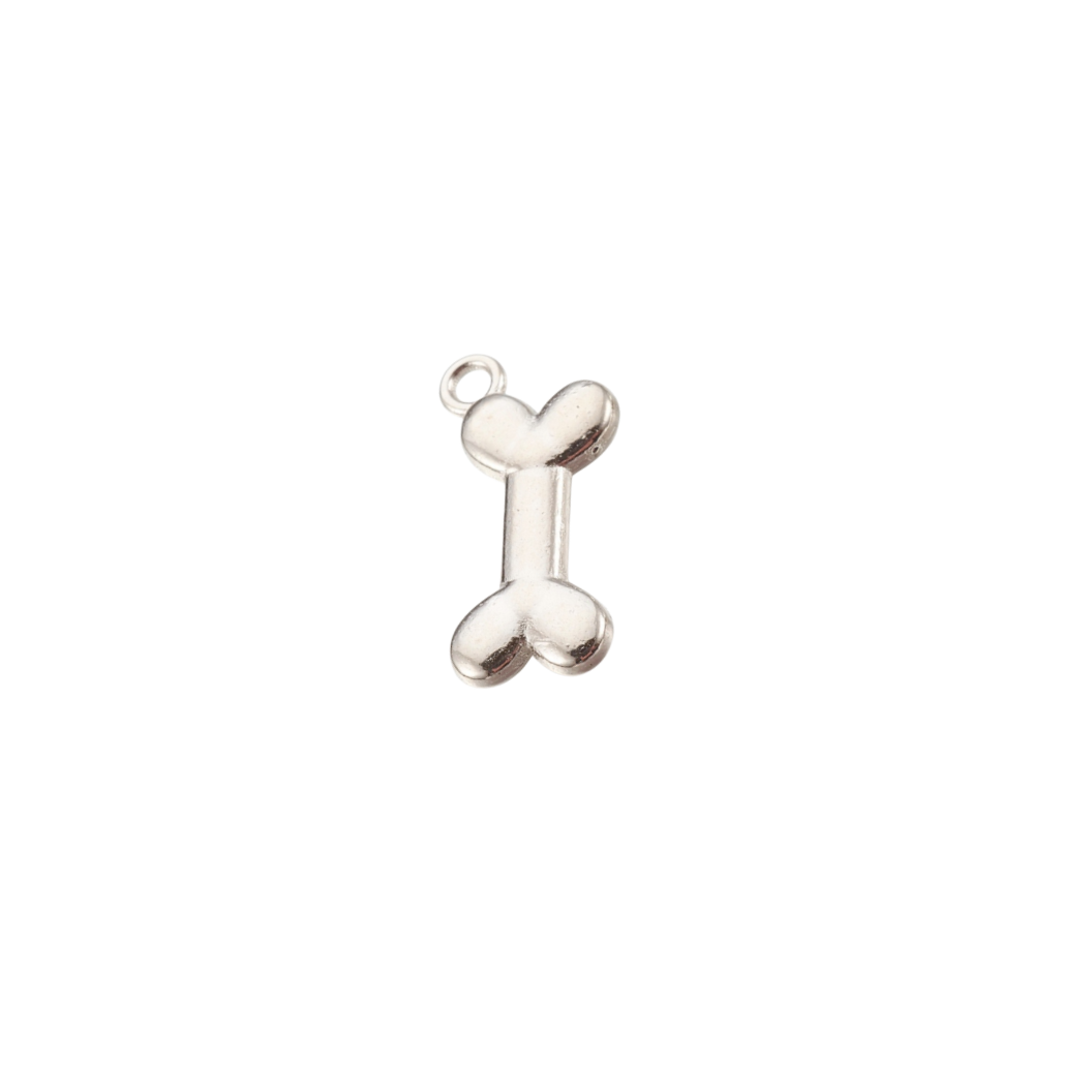 Silver bone-shaped charm on a white background