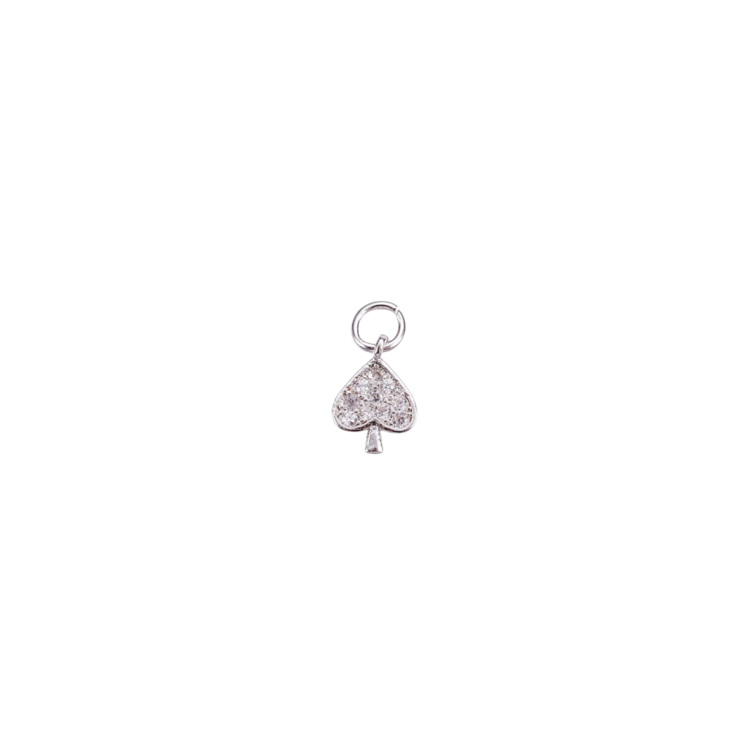 Silver charm shaped like a spade with embedded stones on a white background
