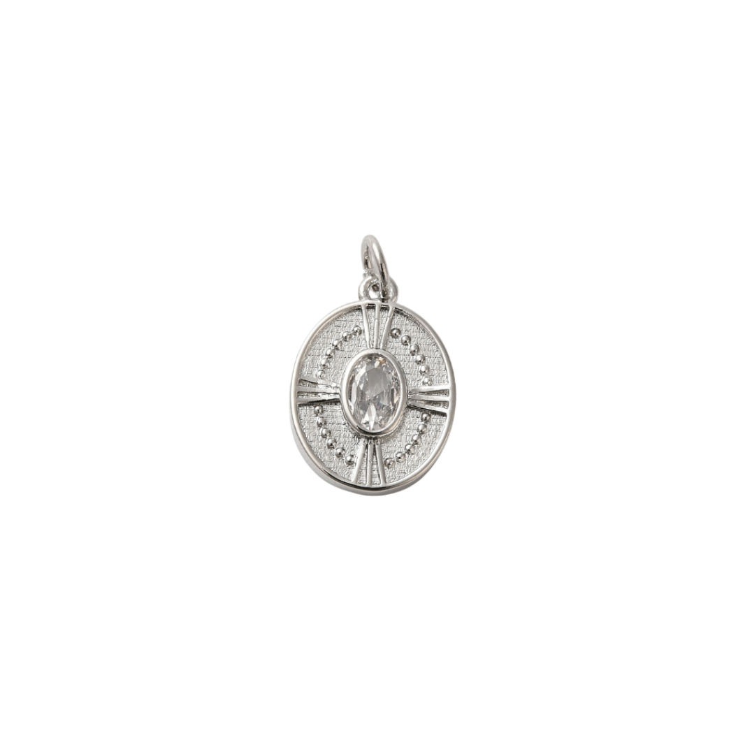 Silver pendant with a central gemstone on a white background