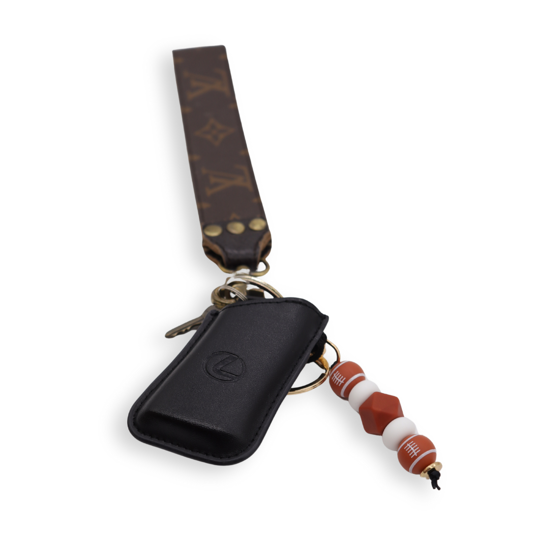 Front of the Brown & White Football Keychain on a set of keys