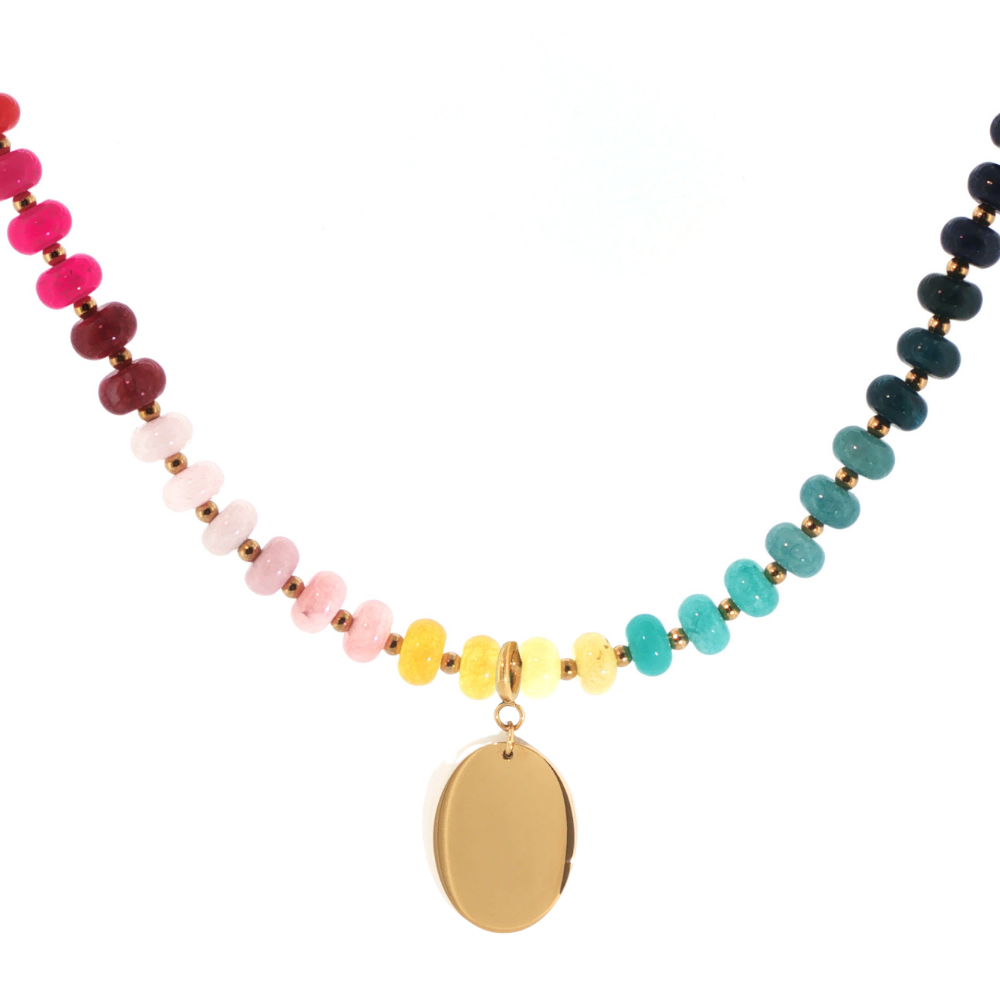Desert Heirloom Beaded Necklace featuring turquoise, navy, pink, red, yellow, and cream beads with gold-tone accents and a smooth oval pendant.