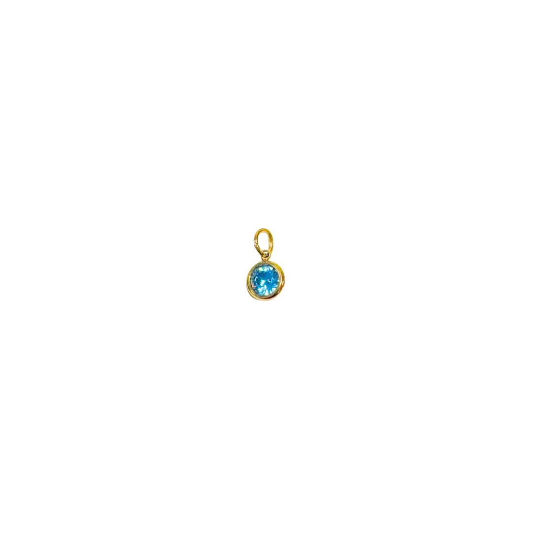 Gold pendant with a blue gemstone on a white background
