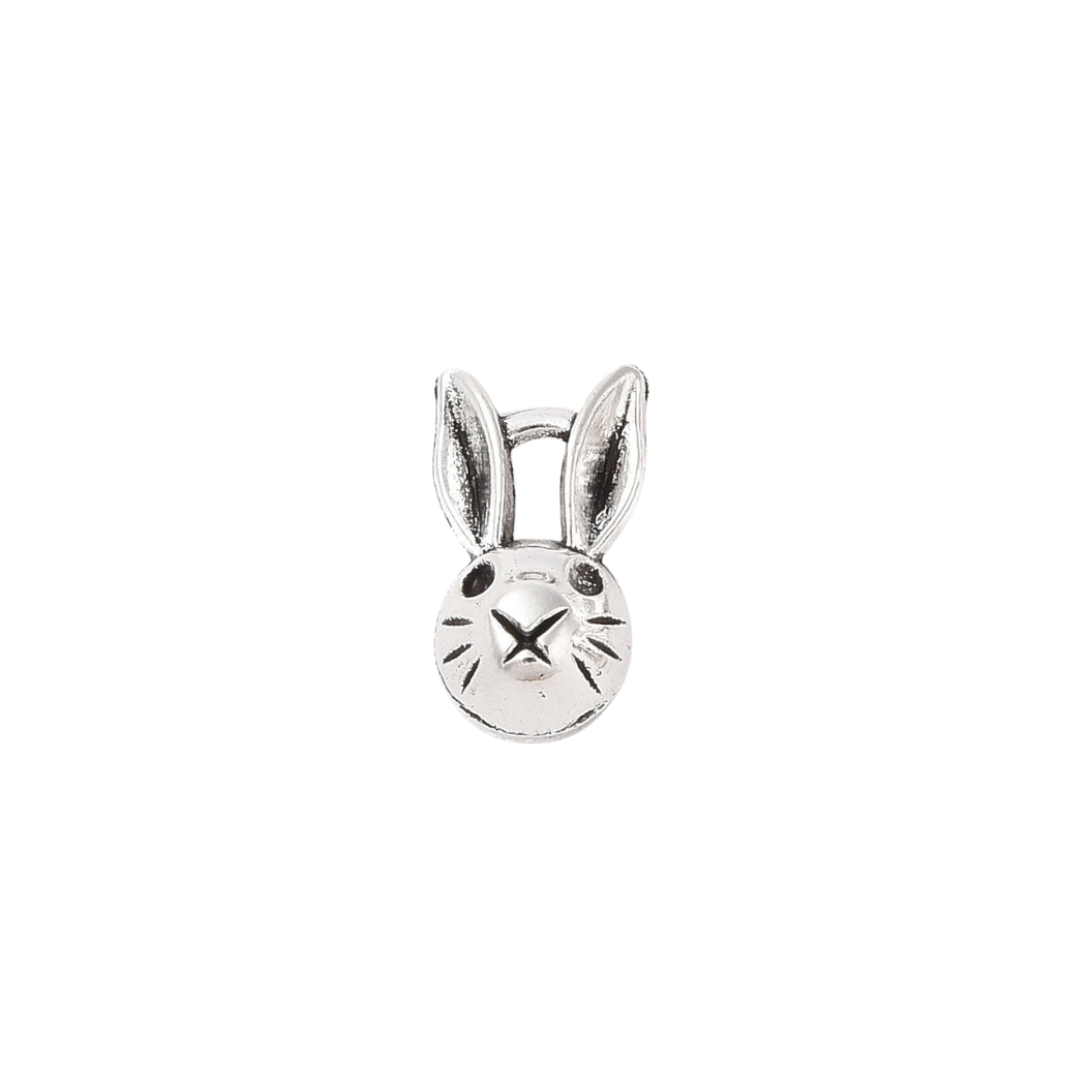 Silver bunny-shaped charm on a white background