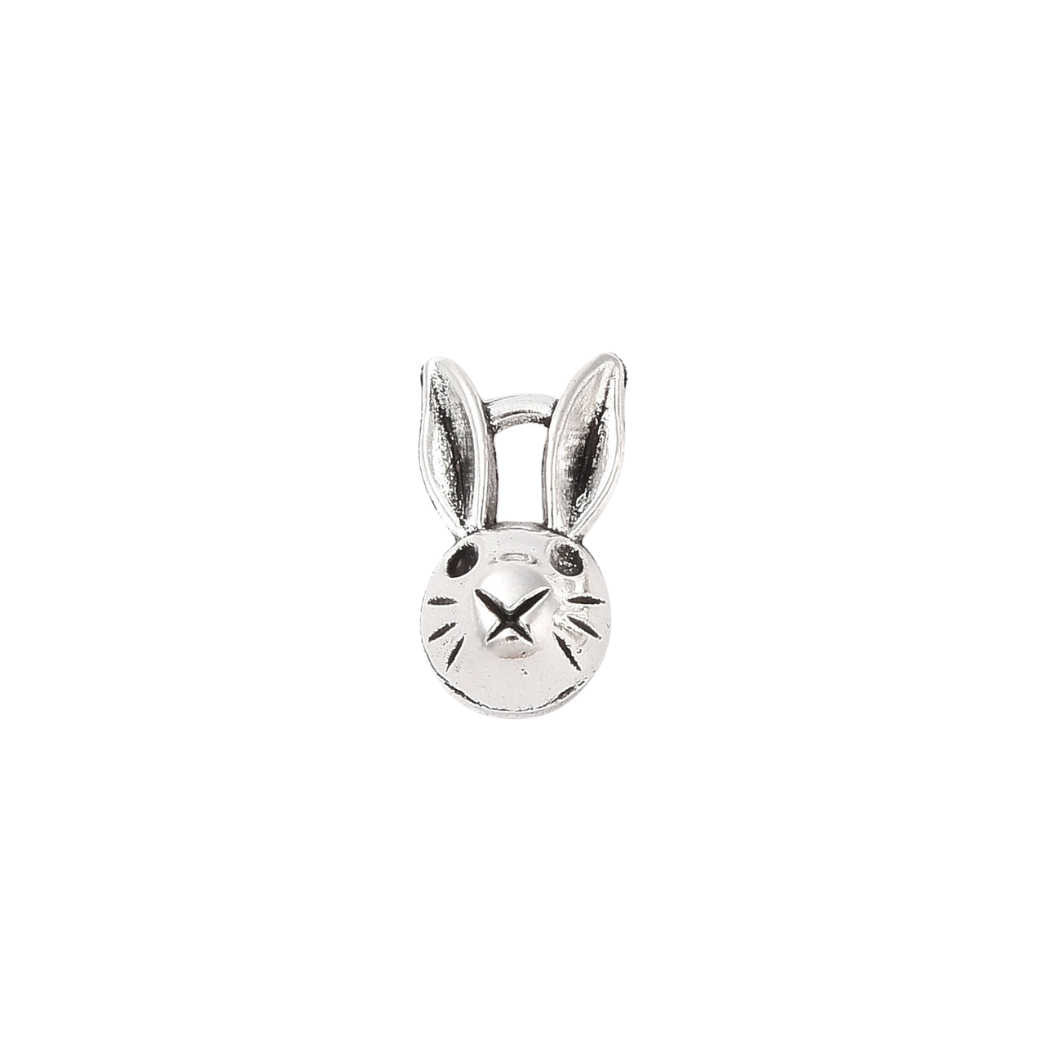 Silver bunny-shaped charm on a white background