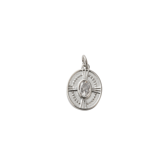 Silver pendant with a central gemstone on a white background