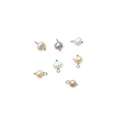 A collection of silver natural freshwater pearl charms with platinum plating and brass accents, displayed against a white background.