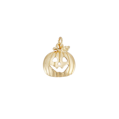 Gold pumpkin charm with a face on a white background