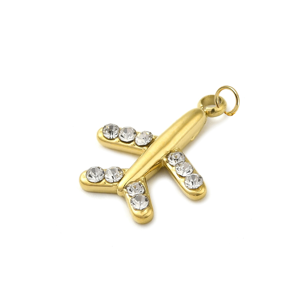 Gold cross pendant with embedded crystals on a white background