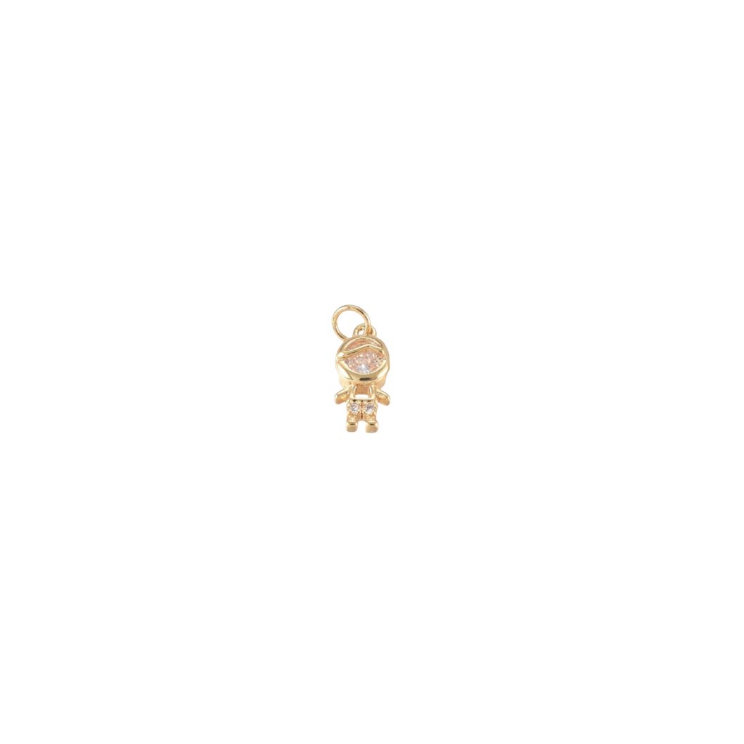 Gold charm with a small boy face design on a white background