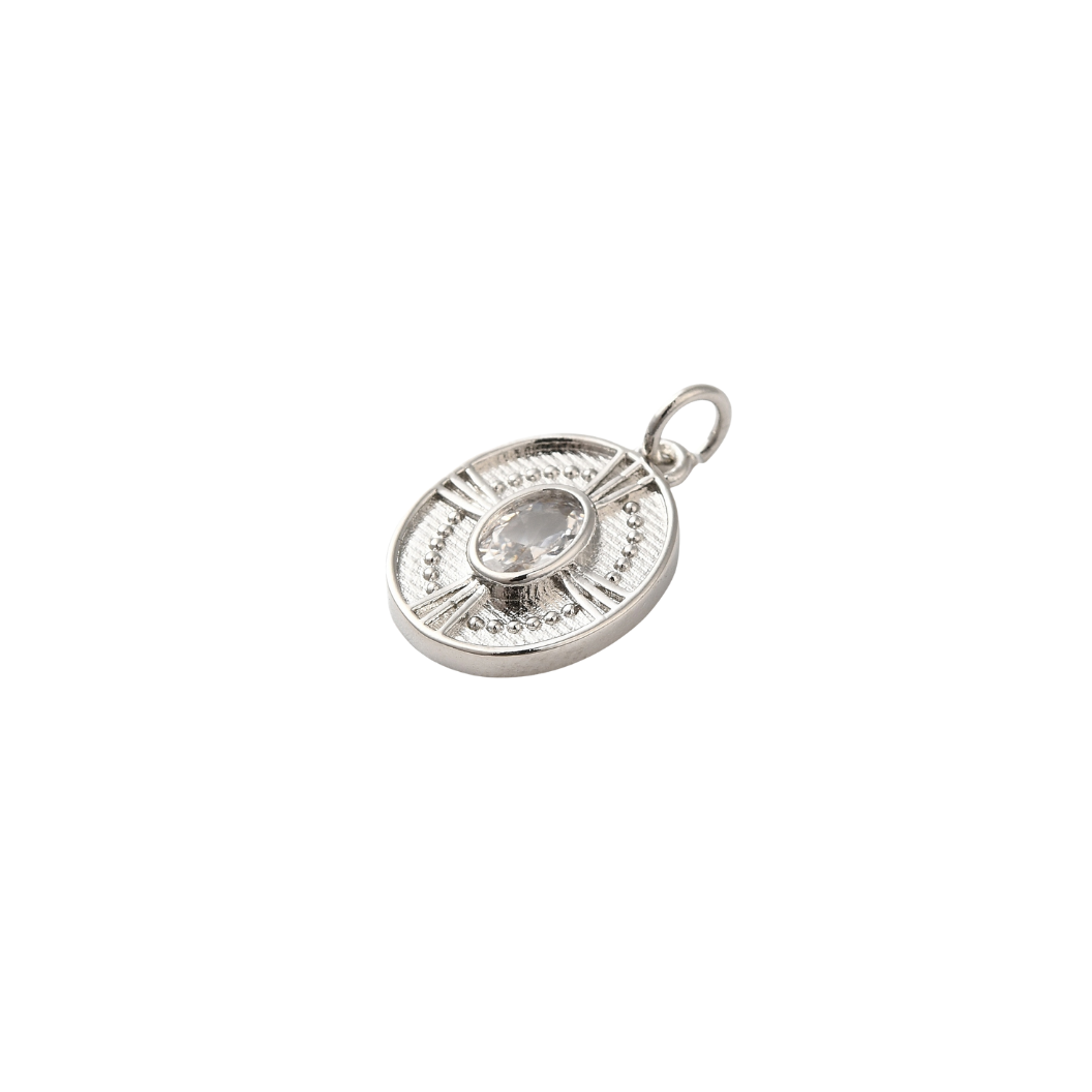 Silver pendant with a central gemstone on a white background