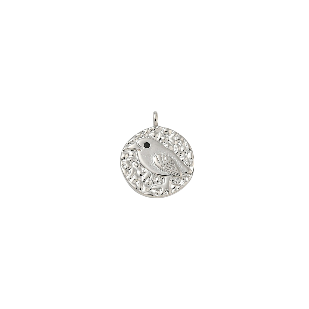 Silver pendant with intricate design on a white background
