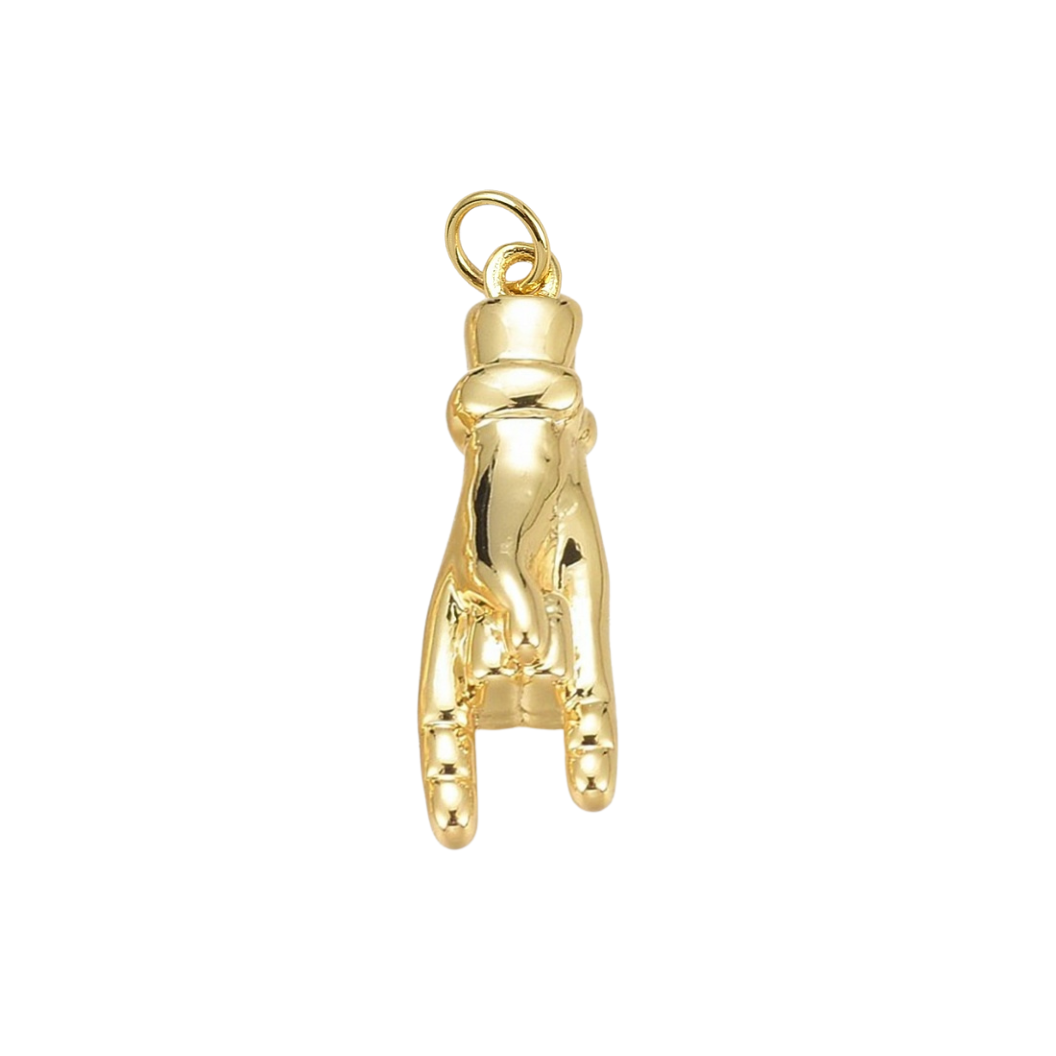 Gold golf club head cover charm on a white background