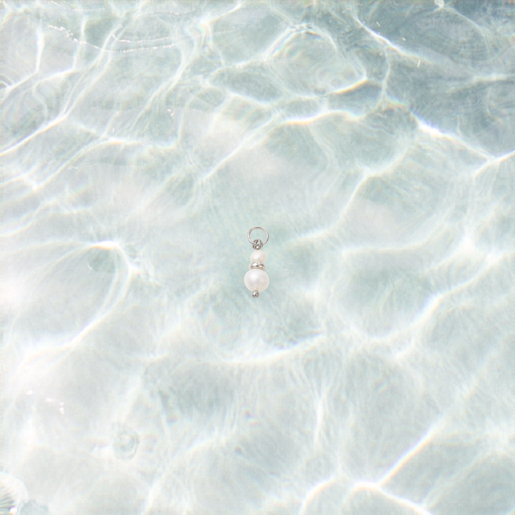 Pearl earring on a textured light blue surface