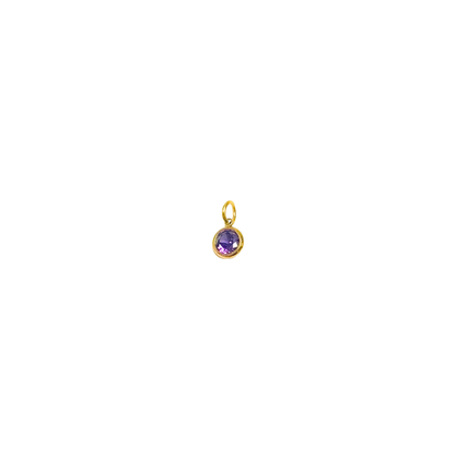 Gold pendant with a purple gemstone on a white background