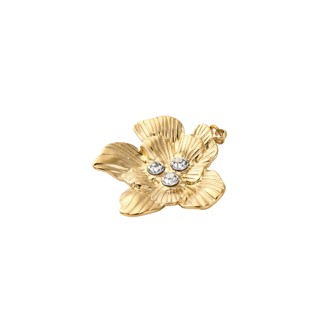 Gold flower-shaped pendant with embedded crystals on a white background