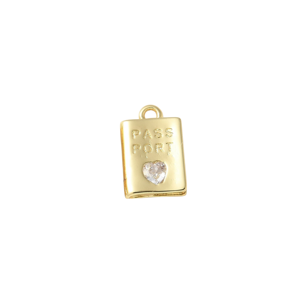 Gold charm shaped like a passport with a heart on a white background
