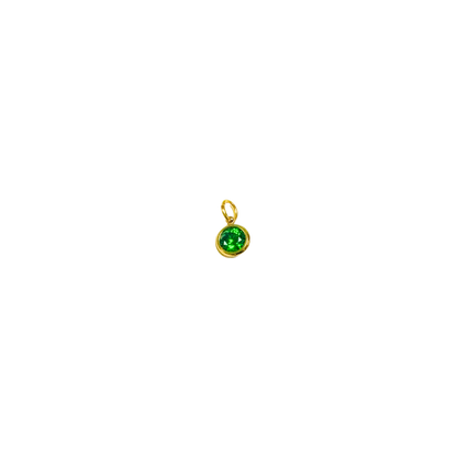 Gold pendant with a green gemstone on a white background