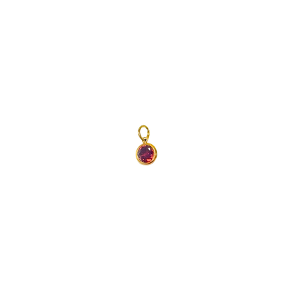 Gold pendant with a red gemstone on a white background