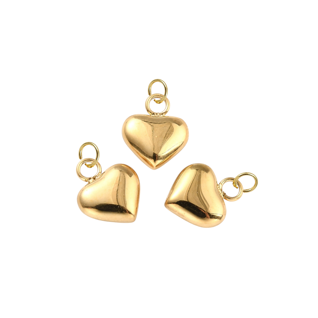Three gold heart-shaped pendants on a white background