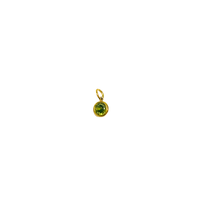 Gold pendant with a green gemstone on a white background