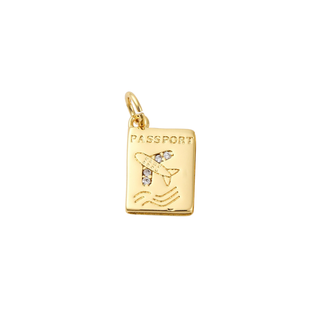 Gold pendant shaped like a passport with an airplane on a white background