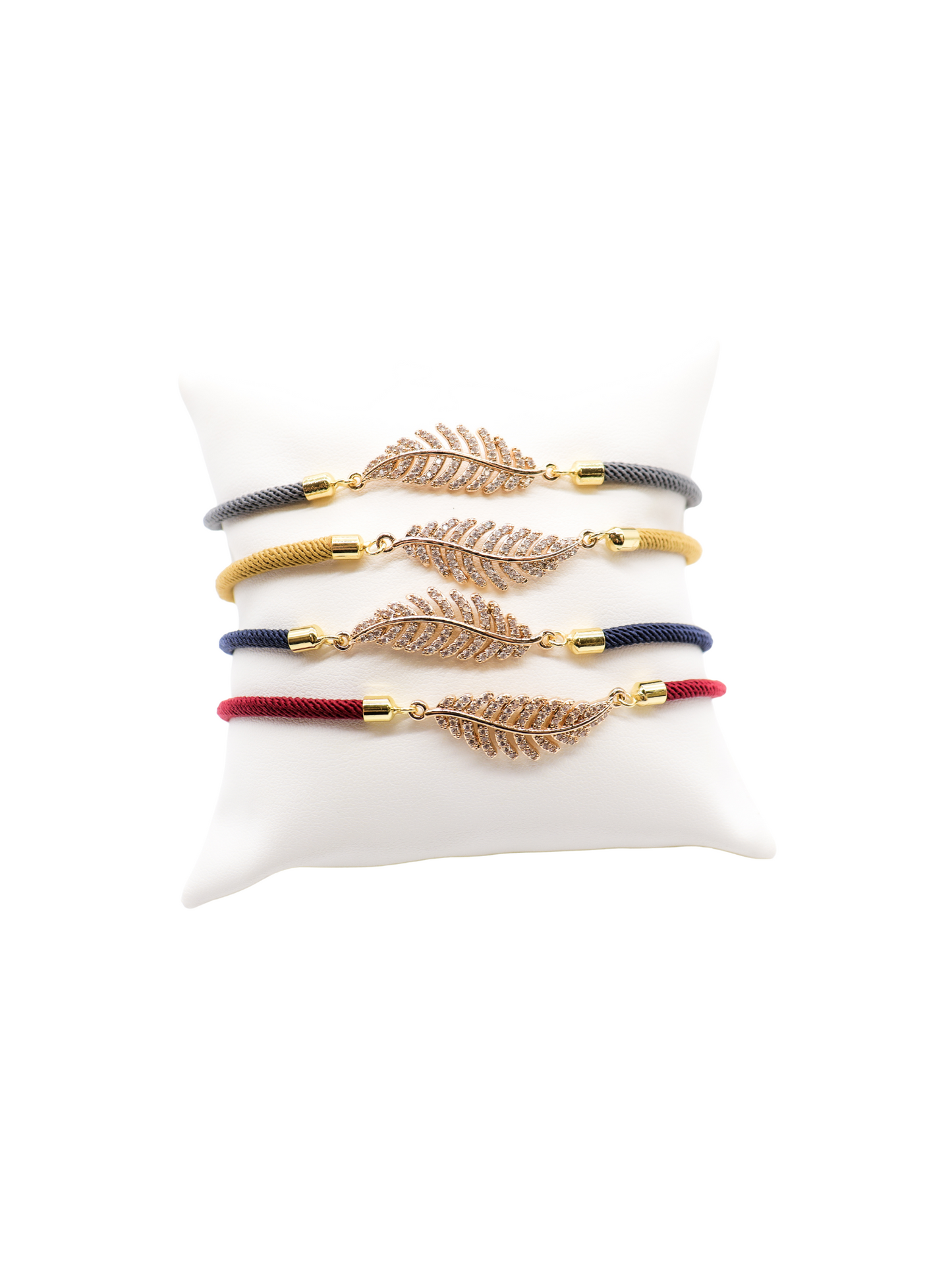 Front of the Cord Bracelets with Feather in gray, mustard, navy, and crimson