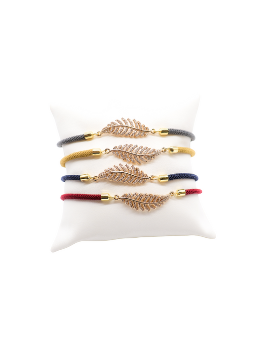 Front of the Cord Bracelets with Feather in gray, mustard, navy, and crimson