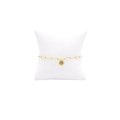 High Point University gold link storyline bracelet with small oval charm with high point university life skills tree on white pillow front view
