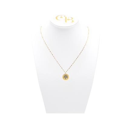 High Point University gold twist necklace with small round charm with high point university life skills tree on white pillow front view

