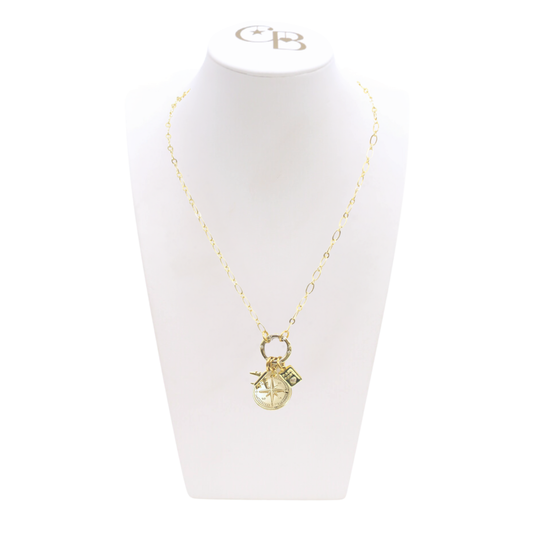 Gold necklace with a pendant on a white mannequin bust