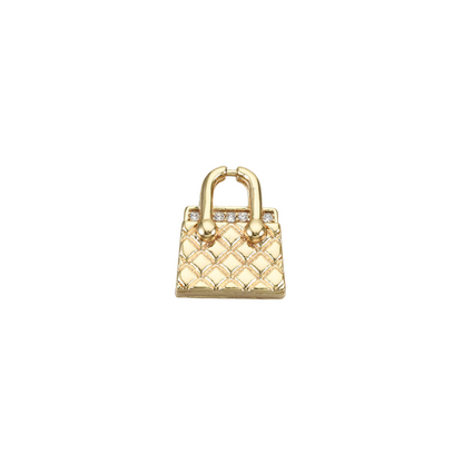 A gold micro pave cubic zirconia handbag charm with quilted details and sparkling crystal accents.