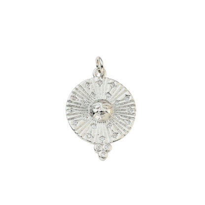 Silver pendant with face design on a white background