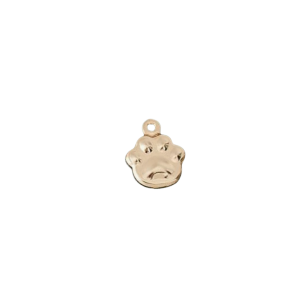 Gold paw print charm on a white background