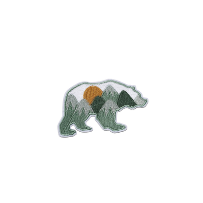 Embroidered patch of a bear with mountain design on a white background