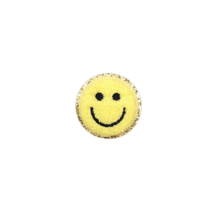 Round yellow object with a smiley face design on a white background