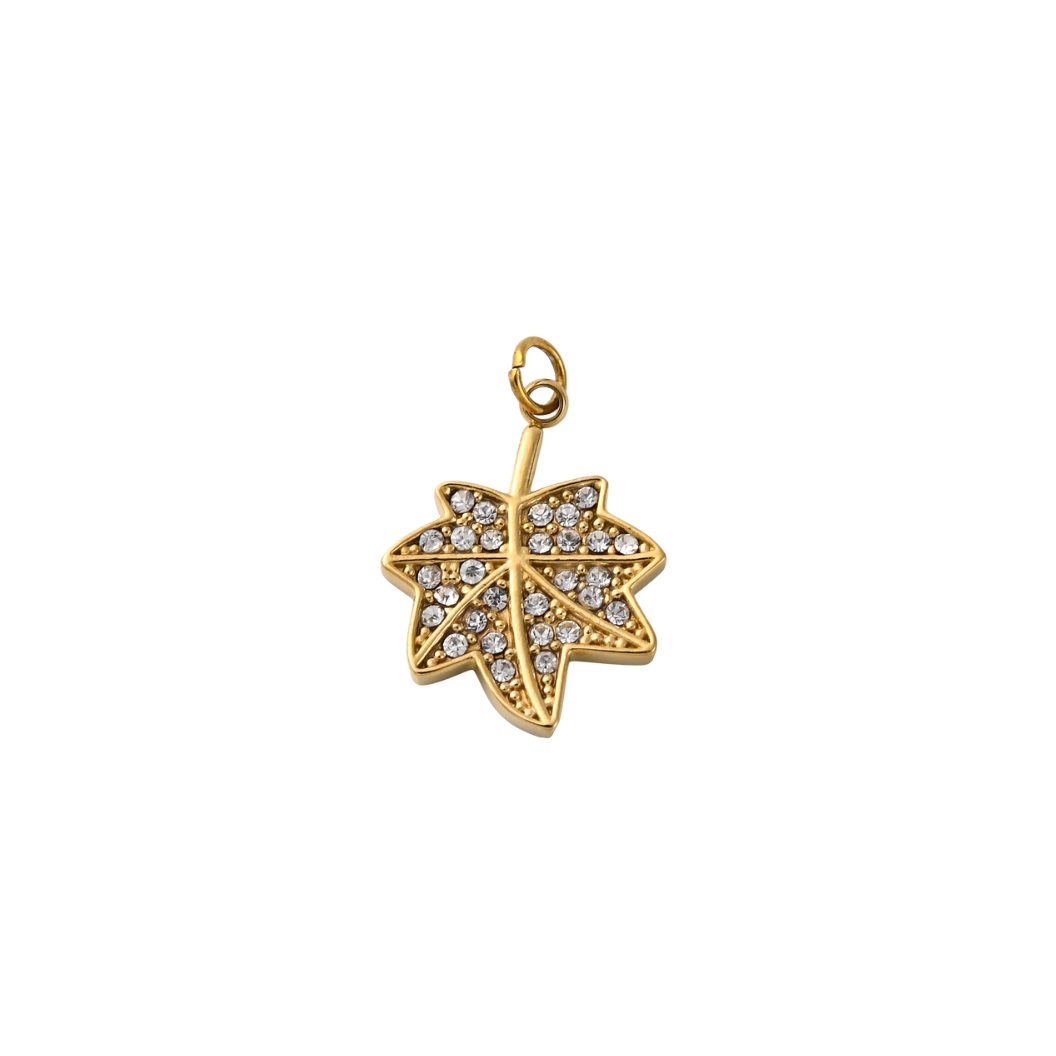 Gold leaf-shaped pendant with embedded crystals on a white background