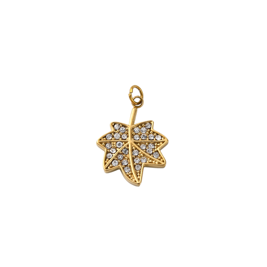 Gold leaf-shaped pendant with embedded crystals on a white background