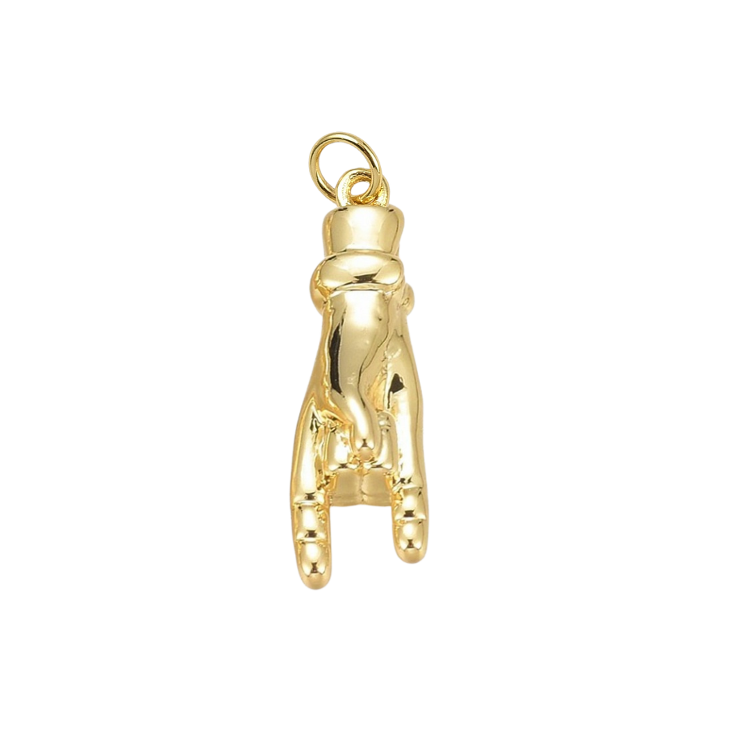 Gold golf club head cover charm on a white background