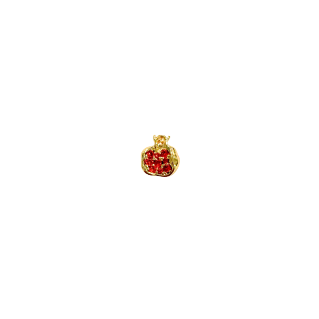 Gold pendant with red heart design on a white background