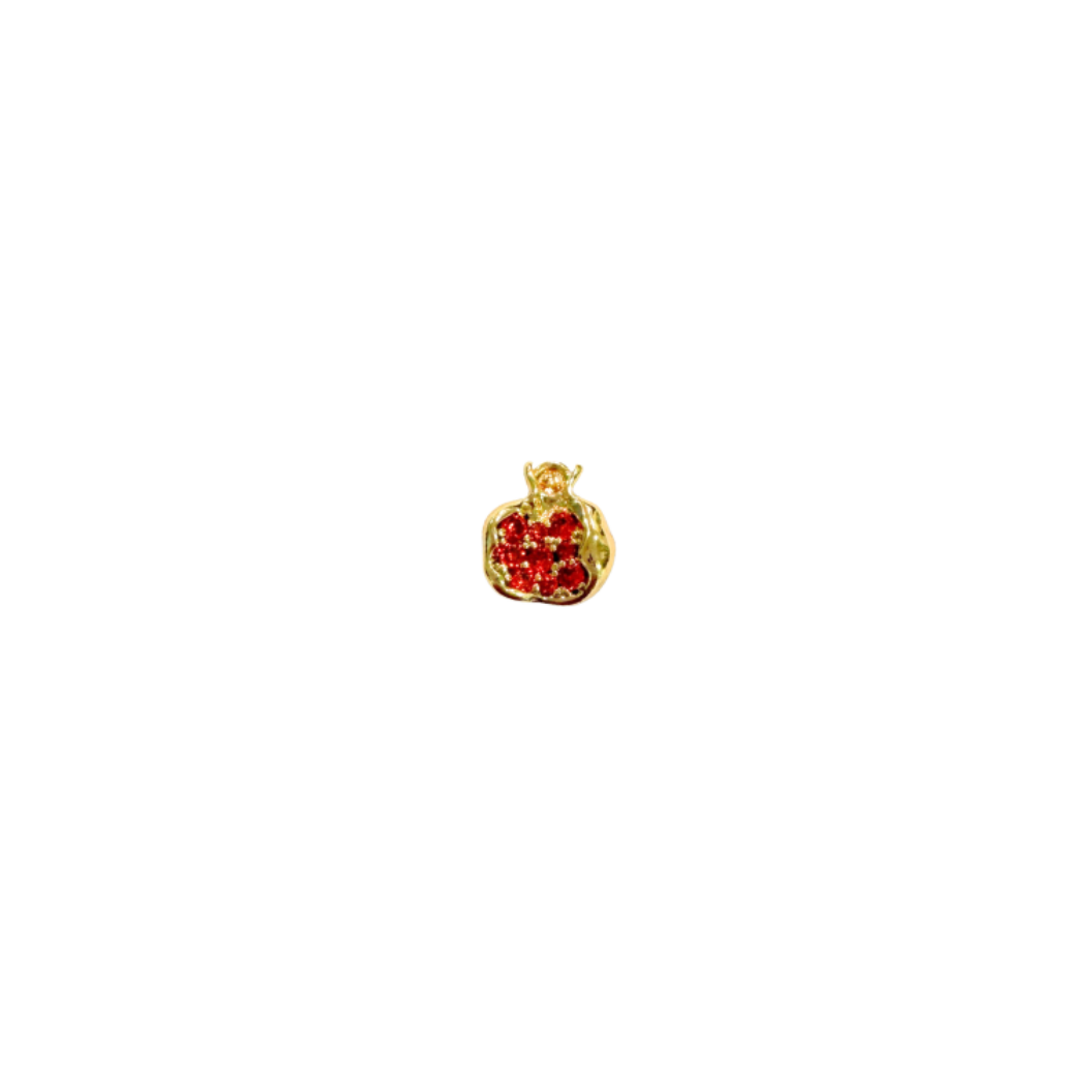 Gold pendant with red stones on a white background