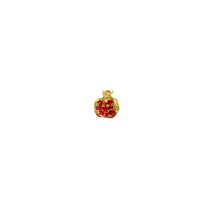 Gold pendant with red stones on a white background