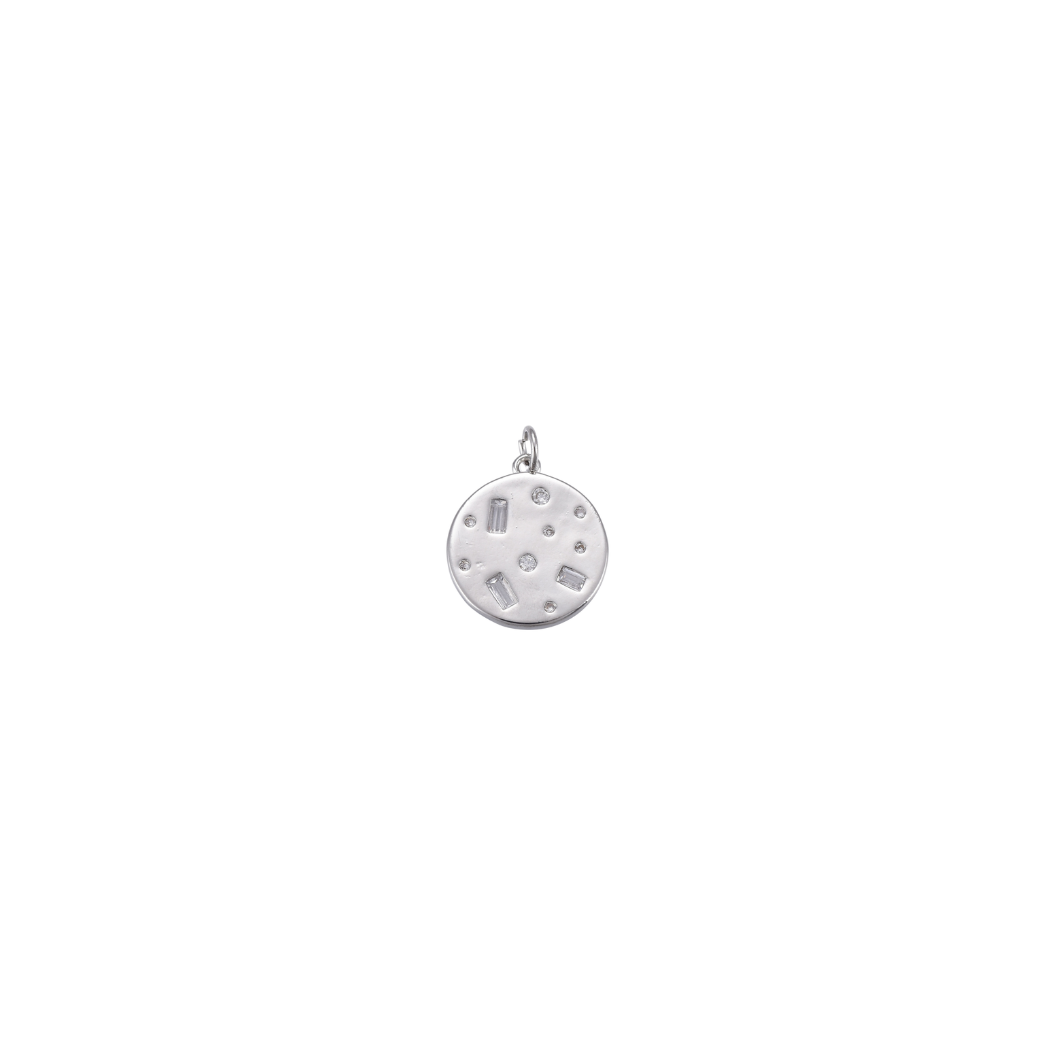Silver pendant with engraved design on a white background