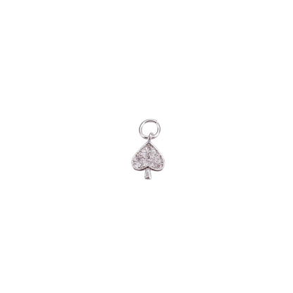 Silver charm shaped like a spade with embedded stones on a white background