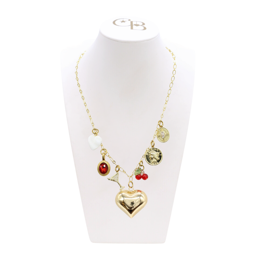 Necklace with heart-shaped pendant and various charms on a white stand with 'CB' logo.