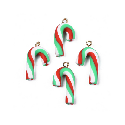 A collection of four candy cane lanyard charms with red, green, and white colors and metallic rings.