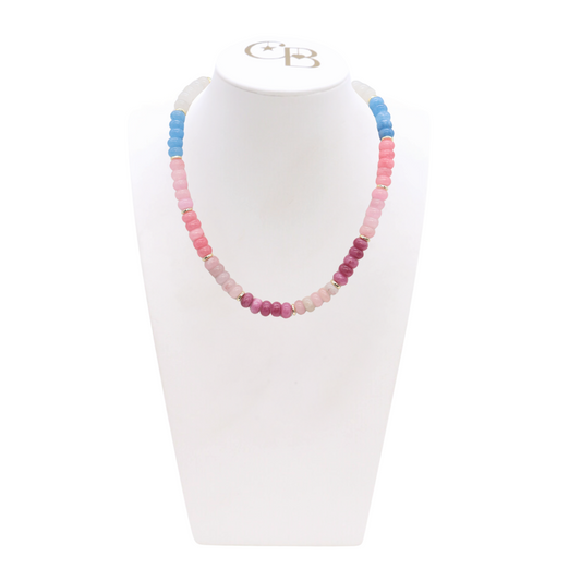 Necklace with multicolored beads on a white stand with a visible brand logo.  Cotton Candy Coast Beaded Necklace